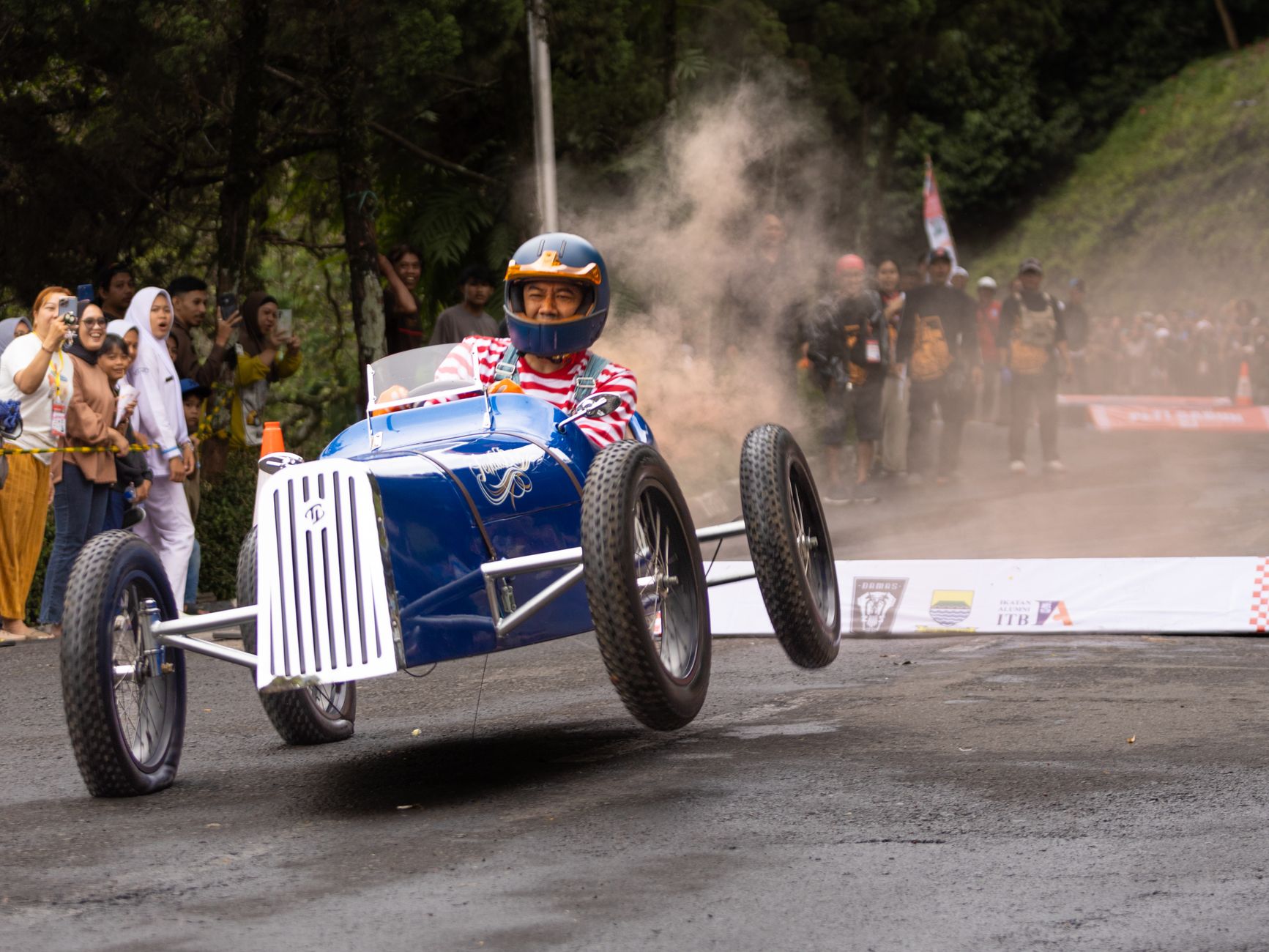 Youth soapbox derby racers in handcrafted gravity carts