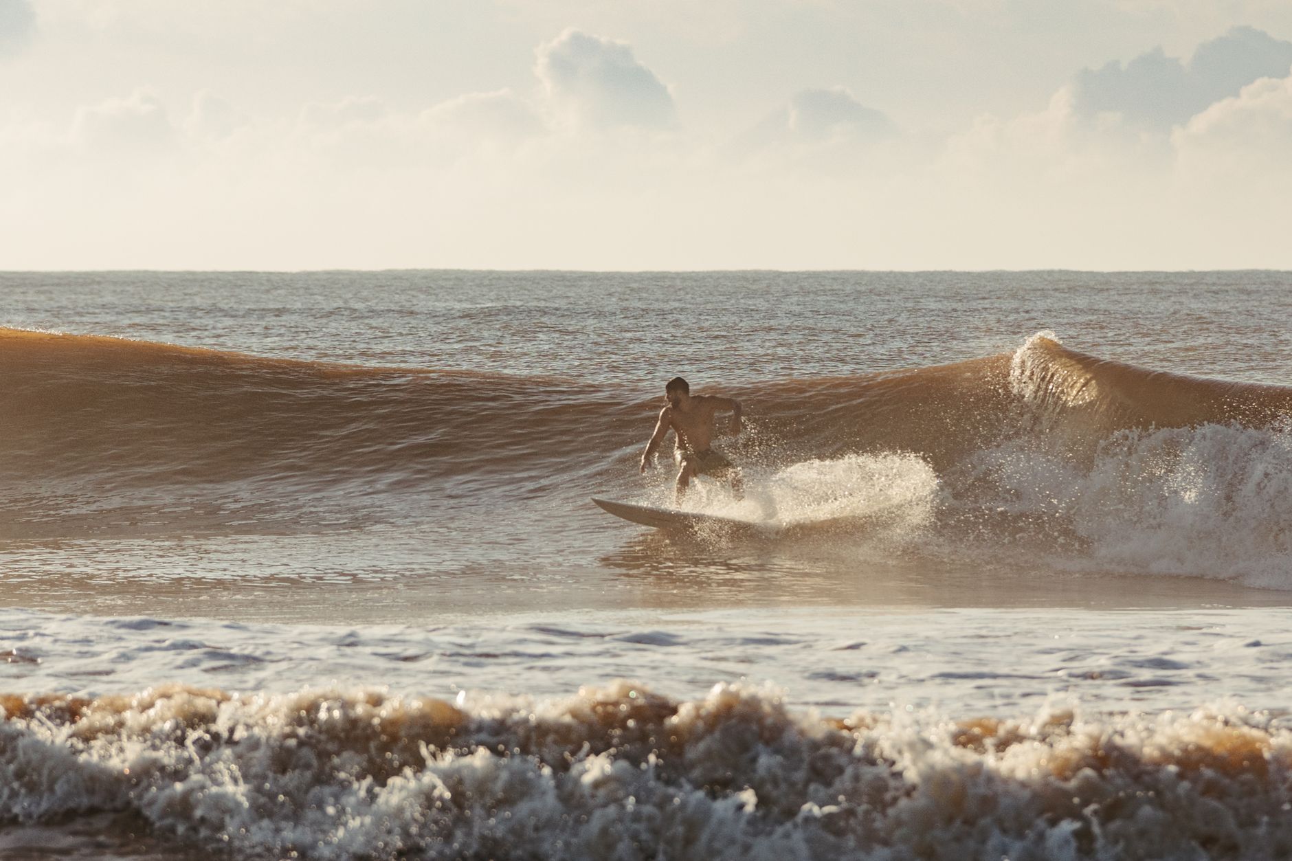 Volunteer surfers share the calm and exhilaration of ocean waves with autistic youth