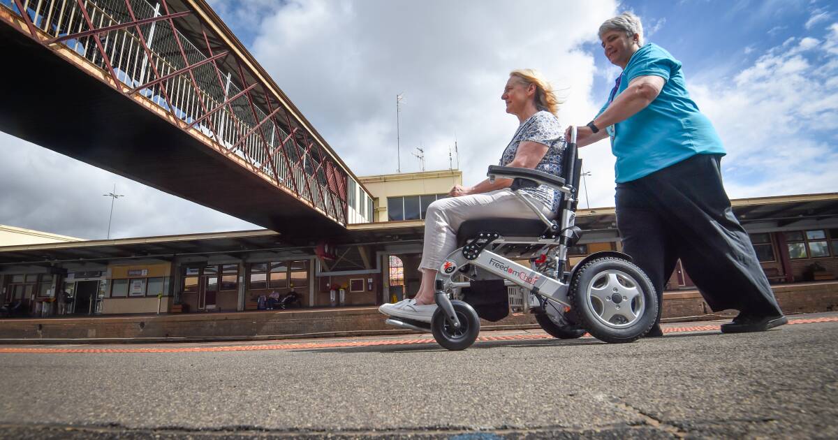 Therese Robinson (left) and Travellers Aid volunteer Paula McCluskey demonstrating the accessibility aid device available for use at Bendigo Station as part of the Travellers Aid service. Picture by Darren Howe